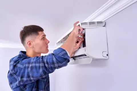 Ray-Z technician installing air conditioning unit in Calgary