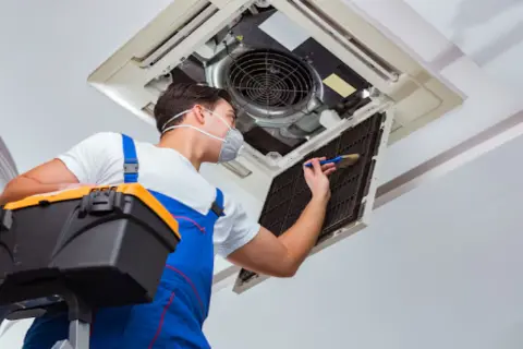 Ray-Z technician repairing air conditioner in Calgary