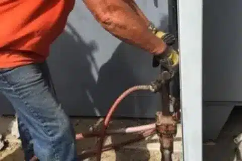 Certified technician installing BBQ gas line in Calgary