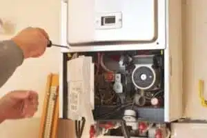 Technician doing boiler maintenance in Calgary home