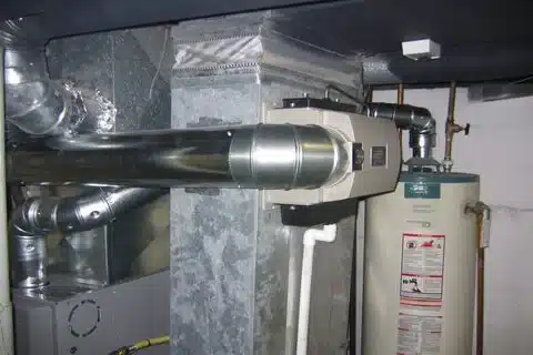 Technician repairing humidifier in Calgary home