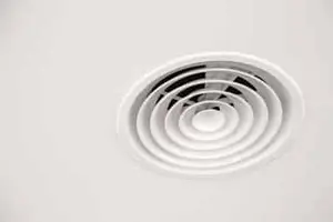 Technician installing residential ventilation system in Calgary home