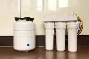 Technician installing water filtration system in Calgary