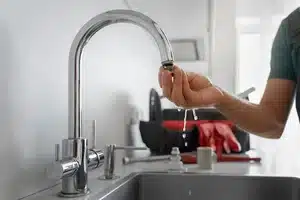 Technician repairing water softener system in Calgary home