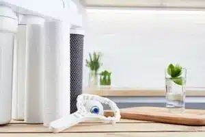 Technician installing water treatment system in Calgary home