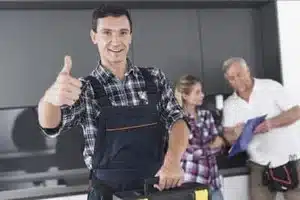 Calgary plumber fixing burst pipe in flooded kitchen