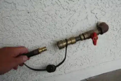 Gas technician repairing outdoor BBQ gas line in Calgary