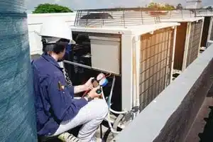 Crane lifting rooftop HVAC unit into place