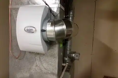Whole-home humidifier system installed by technician