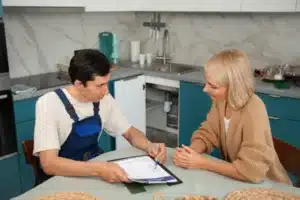 Calgary technician reviewing furnace financing plan with homeowner