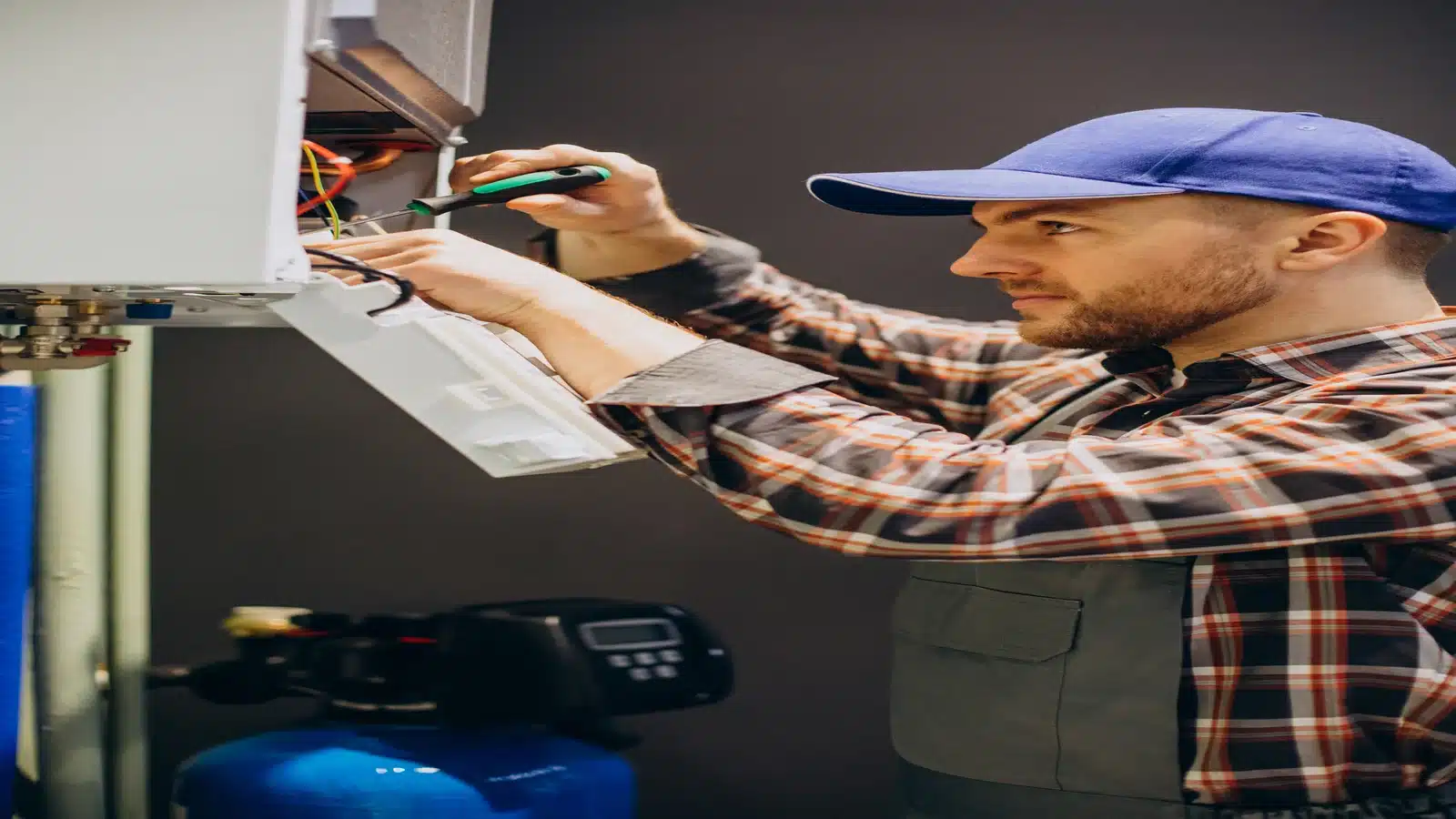 Technician repairing a furnace in Calgary home