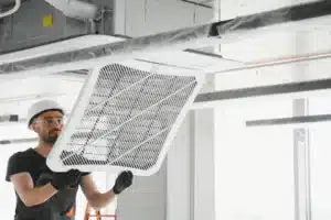 Technician performing HVAC load testing in Calgary home