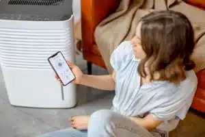 Technician installing UV air purifier in Calgary HVAC system