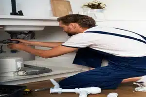 Technician installing underground water line in Calgary