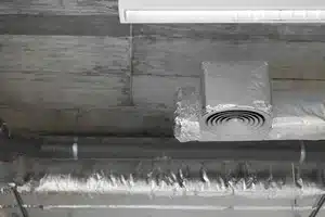 Basement dehumidifier unit connected to HVAC in Calgary home
