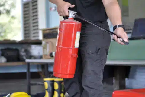 Employees using fire extinguishers during workplace training