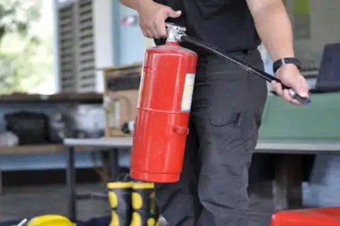 Technician pressure-testing a fire suppression cylinder