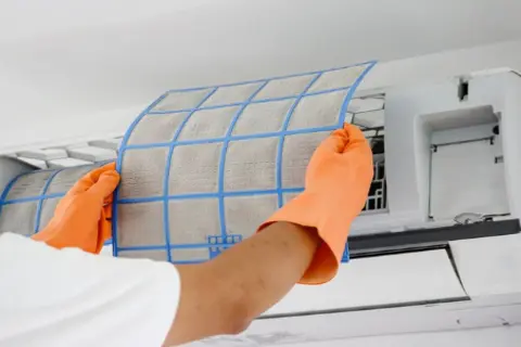Ray-Z technician cleaning indoor AC coils in Calgary