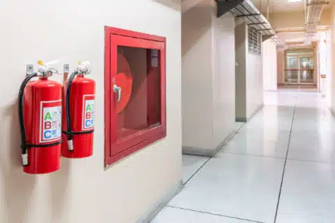 Mounted fire extinguisher in Calgary industrial building