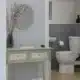 Expert plumber installing a Saniflow toilet system in a modern Calgary home bathroom setup