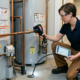 A professional Ray-Z Plumbing and Heating technician performing expert plumbing inspection services in Calgary.